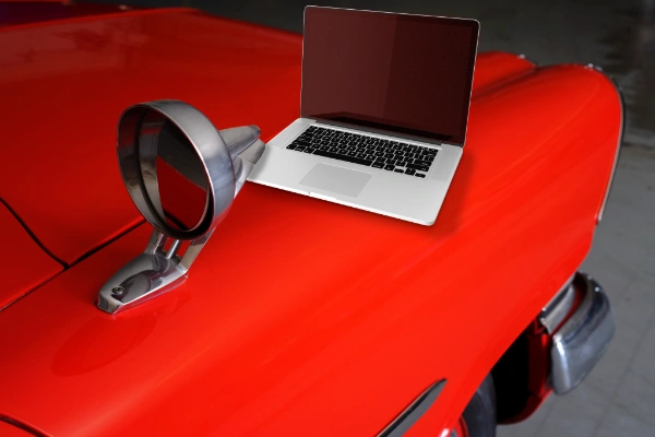 website is like owning a car analogy using red car with laptop on hood maryann davidson